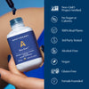 Hand holding Apothékary Blue Burn tincture with dropper dispensing liquid. Icons and text highlight product claims: Non-GMO Project Verified, no sugar or calories, 100% real plants, 3rd party tested, alcohol-free, vegan, gluten-free, and female-founded.